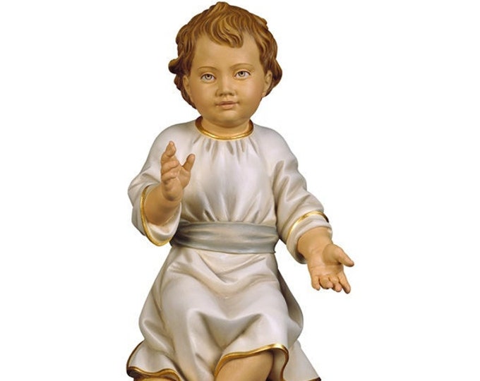 Statue sculpture of the seated baby Jesus, carved in wood from Valgardena and decorated by hand of Italian artisan production