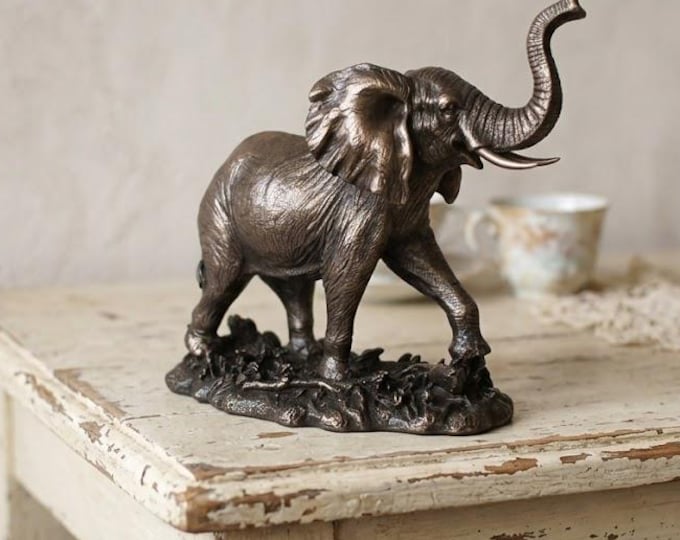 Classical sculpture of an elephant with raised trunk, 16 cm (6.29 inches) in bronzed resin marble, handcrafted in Italy