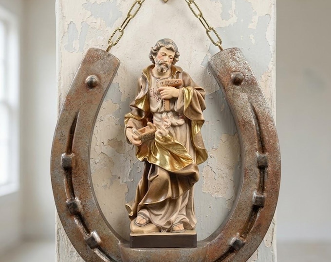 Sculpture of St. Joseph on a horseshoe, carved in Valgardena wood and hand-decorated, artisanally produced in Italy.