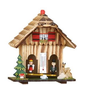 May include: Wooden chalet-style thermometer with a pitched roof, red shutters, and decorative figures. The chalet features a thermometer, a small fir tree, a mushroom, and a deer. The figures include a man and a woman in traditional attire.
