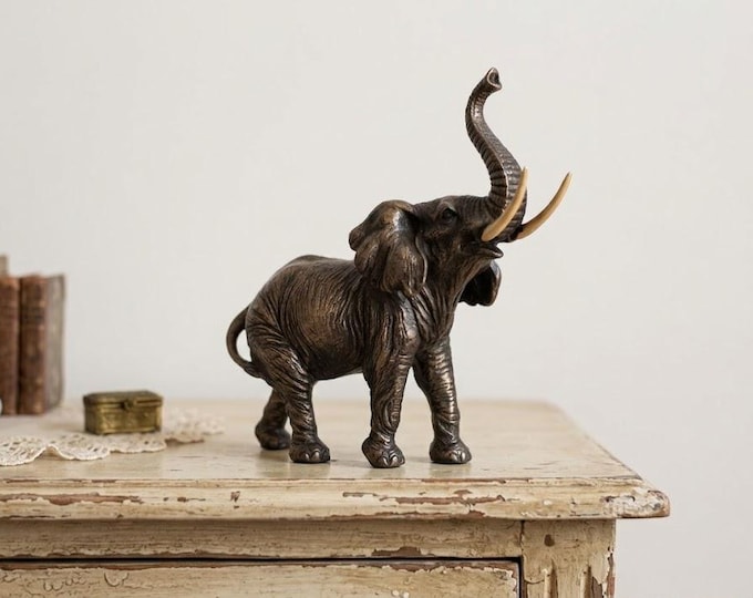 Classical sculpture of an elephant with raised trunk, 11 cm (4.33 inches) in bronzed resin marble, handcrafted in Italy