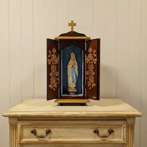 Handcrafted wooden case with damask interior featuring a 27 cm (10.62 inches) foldable statue of Our Lady of Lourdes