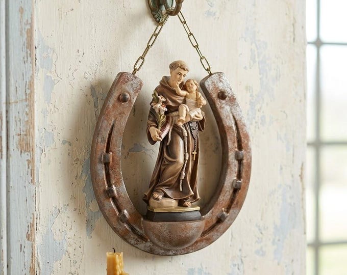 Sculpture of Saint Anthony of Padua on a horseshoe, carved in Valgardena wood and hand-decorated, made in Italy.