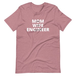 May include: A heather pink t-shirt with the text "MOM WIFE ENGINEER" in white.