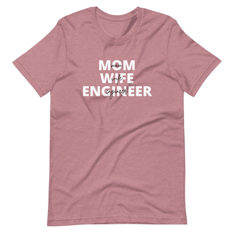 May include: A heather pink t-shirt with the text "MOM WIFE ENGINEER" in white.