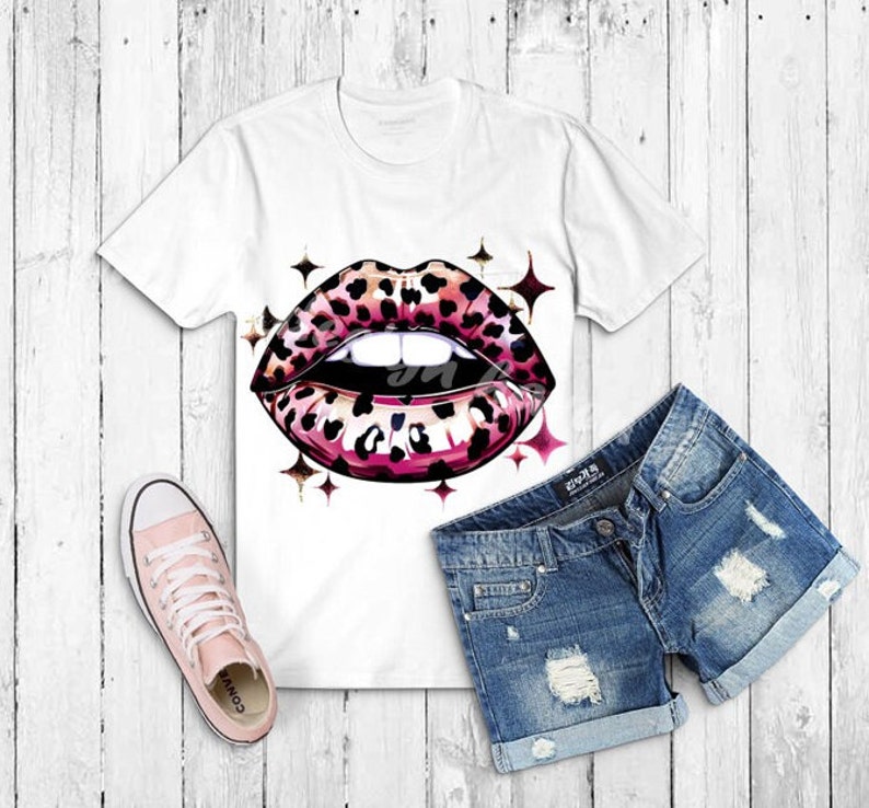 a t - shirt with a leopard print on it next to a pair of shorts