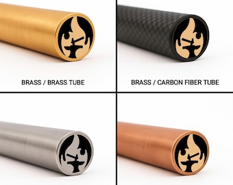 May include: Four cylindrical tubes with a logo on the end are displayed. The tubes are made of brass, carbon fiber, stainless steel, and copper. The logo is a black and tan design of a flame and anvil. Text below each tube identifies the material.