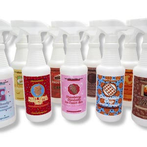 May include: A collection of white spray bottles with various labels. The labels feature colorful designs and text, including "Fruity Cereal Marshmallow Treat," "Strawberry Shortcake Ice Cream Bar," and "Chocolate Chip Cookie Dough."