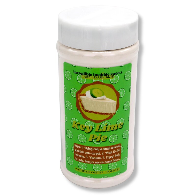 May include: A white plastic container with a white lid, labeled "Key Lime Pie" carpet deodorizer. The label features a slice of key lime pie and instructions for use. The net weight is 6 oz.