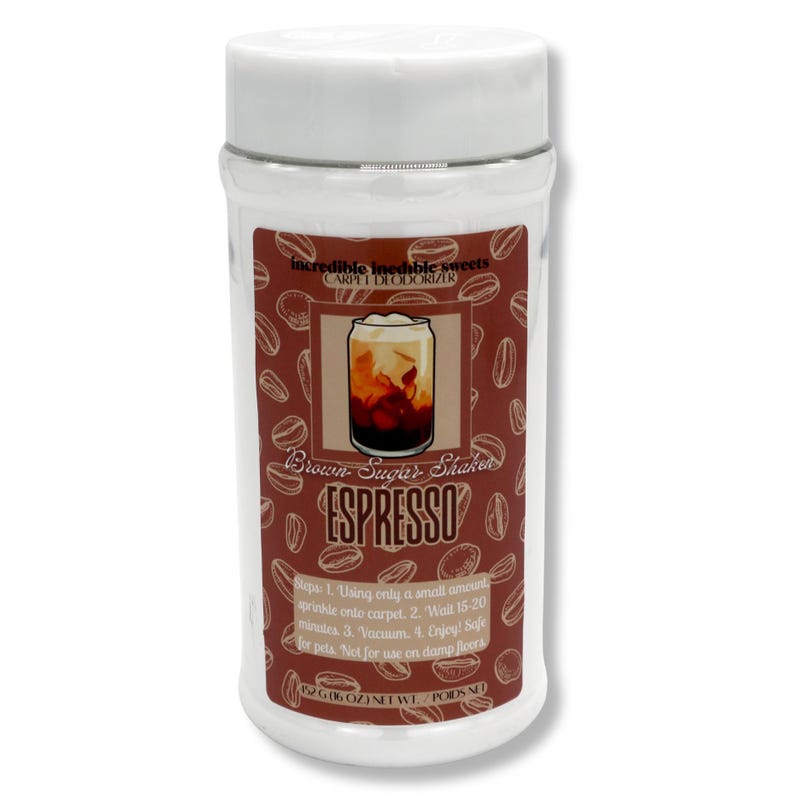 May include: A white plastic container with a brown label featuring coffee beans and a coffee drink illustration. The label reads "Brown Sugar Shaker ESPRESSO" and "Carpet Deodorizer". The container is filled with a powder.