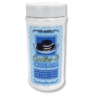 May include: A white plastic container of carpet deodorizer with a white lid. The label features a blue background with a graphic of cookies and cream. Text on the label reads "Cookies & Cream" and "incredible inedible sweets CARPET DEODORIZER".