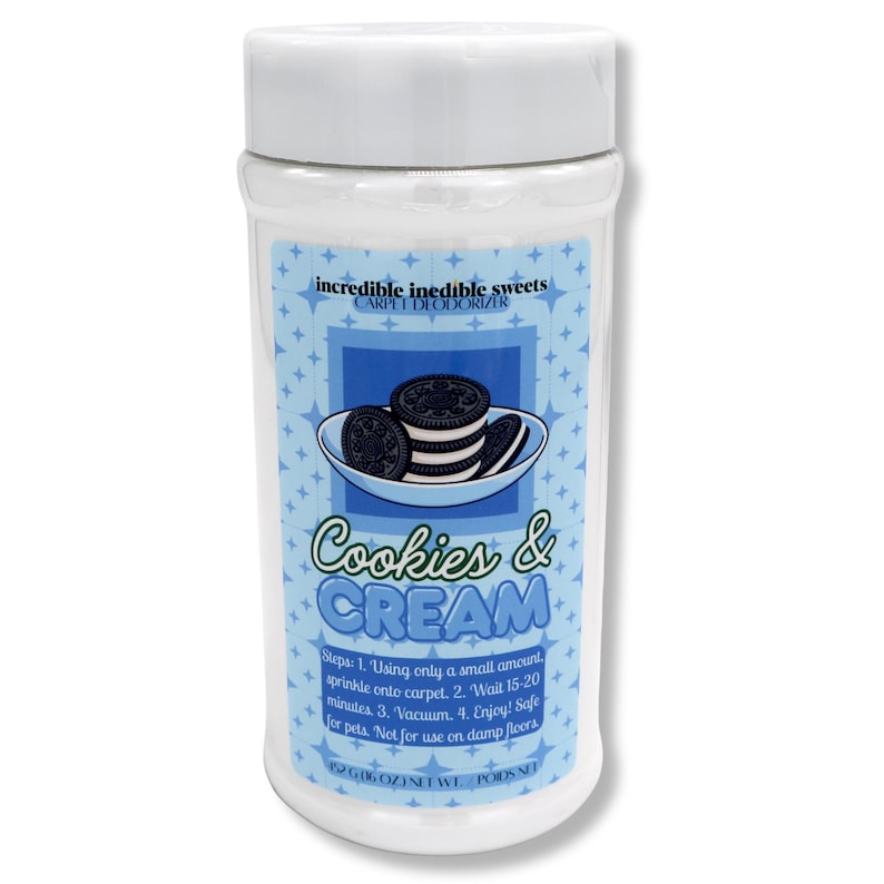 May include: A white plastic container of carpet deodorizer with a white lid. The label features a blue background with a graphic of cookies and cream. Text on the label reads "Cookies & Cream" and "incredible inedible sweets CARPET DEODORIZER".
