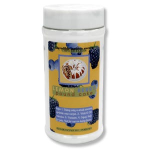 May include: A white cylindrical container of carpet deodorizer. The label is yellow with illustrations of blueberries and blackberries. Text on the label reads "Lemon Berry Pound Cake" and "Incredible Inedible Sweets Carpet Deodorizer."