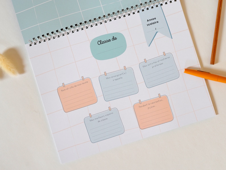 May include: A light blue and peach colored printable worksheet with a grid pattern. The worksheet has several sections with headings in French, including "Classe de", "Nom et ville de mon ecole", "Mon enseignant(e)", "Mes activites et matieres preferes", "Mes meilleurs copains de classe", and "Pendant la recreation, je joue".