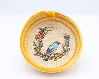 Orange variegated rope bowl with indigo bunting and wreath