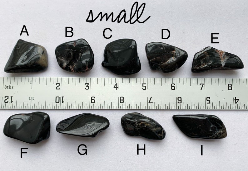 A photo of all of the small stones, labelled with their corresponding letters, lined up against a ruler (in inches). Stones A, B, C, D, and E are shown above the ruler and stones F, G, H, and I are shown below it.