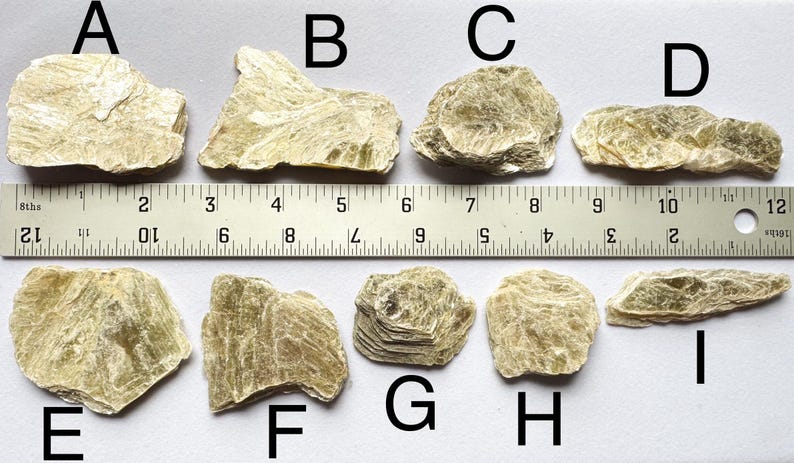 A photo of stones A-I lined up against a ruler (in inches), labelled with their respective letters.