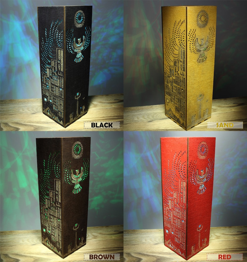 May include: Four wooden lamps with a laser-cut design of an Egyptian god with outstretched wings. The lamps are in black, brown, red, and sand colors.