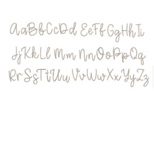 May include: A handwritten alphabet in a light brown color. The letters are written in a cursive style.