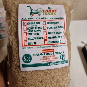 May include: A 5-pound bag of uncooked white rice. The bag is labeled "Naija Foods Texas" and lists various African foods, including "Igbemo Rice (Ekiti)", "Honey Beans (Ewa Oloyin)", "Yam Flour", "Yellow Garri", "Egusi", "Garri Ijebu", "Plantain Flour", "Peeled Beans", "Ofada Rice", and "Ogbonno". The bag also states that the rice is 100% natural, contains no preservatives, and has no artificial colors. The bag is sealed and ready to be used.