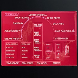 May include: A red washing machine control panel with a white graphic showing different wash cycles, temperatures, and settings. The panel includes options for "Steam Cycle", "Cotton/Normal", "Bulky/Large", "Perm. Press", "Sanitary", "Delicates", "Allergene", "Steam Fresh", "Hand Wash/Wool", "Speed Wash", "Pre-Wash", "Rinse + Spin", "Extra Rinse", "Stain Cycle", "Water Plus", "Wash/Rinse", "Spin Speed", "Soil Level", and "Beeper".