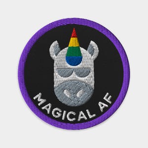 May include: A purple and black embroidered patch featuring a white unicorn with a rainbow horn and the text "Magical AF".