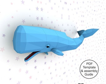 May include: A blue papercraft model of a sperm whale, with a red mouth, against a white background with pink and blue stars. The text "PDF Template & assembly Guide" and "FP DESIGN CRAFTS" is visible in the image.