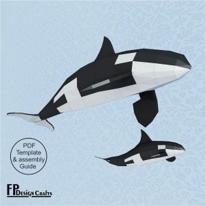 Puede incluir: Dos ballenas orca de papel, una grande y otra pequeña, en blanco y negro. La imagen incluye una plantilla PDF y una guía de montaje. El fondo es azul claro con un estampado floral. El logotipo de FP Design Crafts está en la parte inferior.