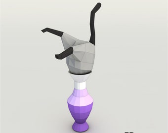 May include: A gray and black origami cat sculpture standing upside down in a purple and white vase.