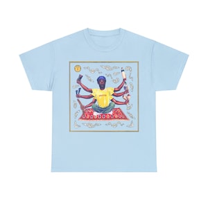 May include: A light blue t-shirt with a graphic print of a person with multiple arms juggling various objects. The person is sitting on a red and gold patterned rug with a yellow shirt that says "Upsetter".