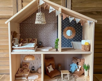 May include: A wooden dollhouse with two levels, featuring a brown and white patterned wallpaper, a small mirror, and a miniature mouse doll. The dollhouse is decorated with miniature furniture, including a bed, a couch, and a table.