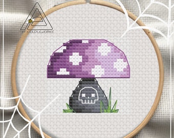 May include: Cross-stitch design featuring a purple mushroom with white spots and a skull on the stem, set within an embroidery hoop. The design includes green grass and the text "PDF PATTERN". The logo "SIR NEEDLEWORKS" is also visible.