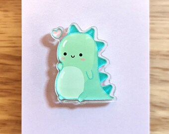 Green dinosaur heart clear acrylic pin— Tiny Pineapple Studio (squishy dino cute kawaii derpy nerdy happy science love monster creature)