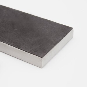 May include: A rectangular black tray with a white border. The tray is made of a smooth, textured material.