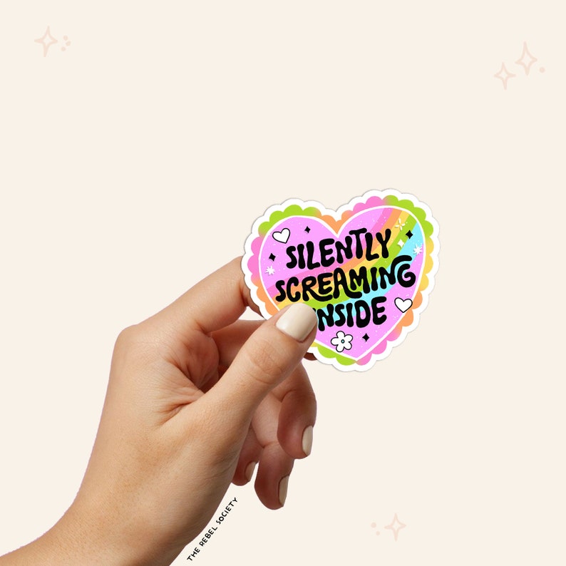 May include: A pink heart-shaped sticker with a rainbow design and the text "SILENTLY SCREAMING INSIDE".