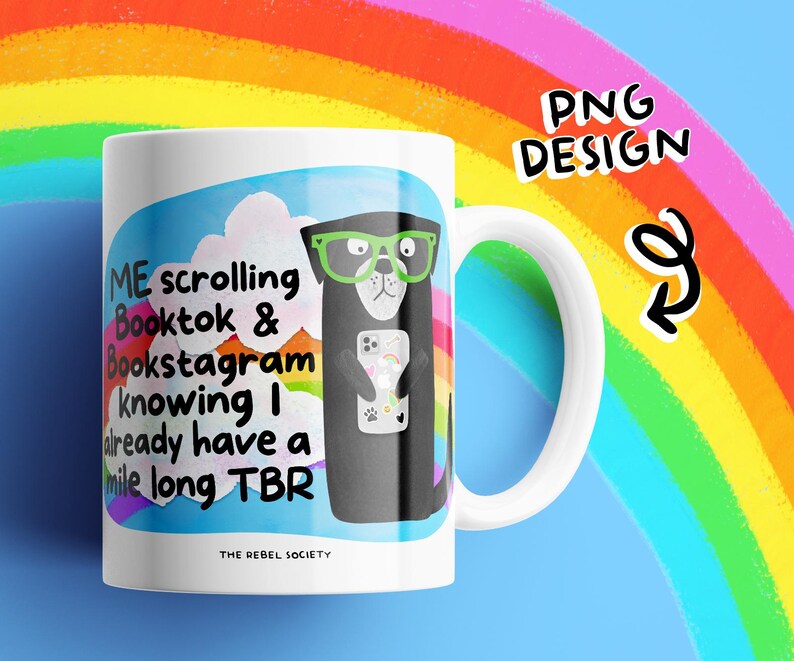 May include: White ceramic mug with a humorous design. The mug features a cartoon otter wearing green glasses and holding a phone. Text on the mug reads "ME scrolling Booktok & Bookstagram knowing I already have a mile long TBR". The mug has a white handle and the words "THE REBEL SOCIETY" at the bottom.