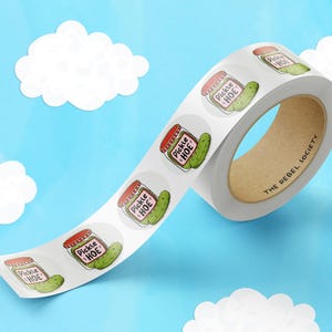 May include: Roll of white sticker labels with a green pickle and red jar design. The stickers say "Pickle Hoe" and "The Rebel Society".