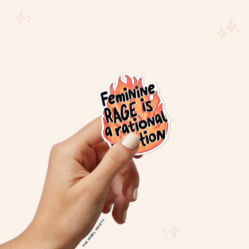 May include: A sticker with a flame design and the text "Feminine Rage is a rational reaction".