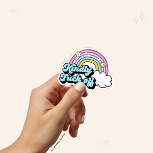 May include: A sticker with a rainbow and a cloud with the text "Kindly Fuck Off" in a retro font. The rainbow is pink, yellow, and blue. The cloud is white. The text is blue.