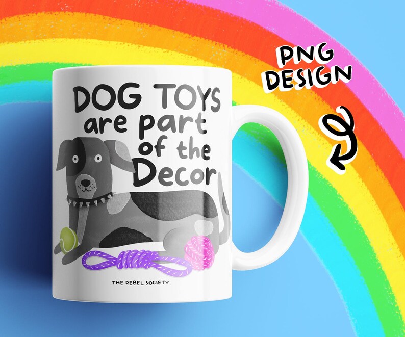 May include: White ceramic mug with a dog illustration and the text "DOG TOYS are part of the Decor". The dog is black and white with a green ball, pink yarn ball, and purple rope toy. The mug has a white handle and the words "PNG DESIGN" are in the top right corner.