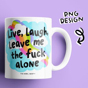 May include: White ceramic mug with a rainbow and clouds design. The text on the mug reads "Live, Laugh, Leave me the fuck alone." The text "The Rebel Society" is printed in smaller font below the design.