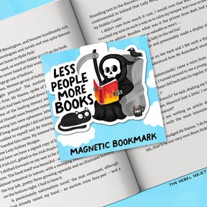 May include: A magnetic bookmark featuring a cartoon Grim Reaper reading a book with flames, a black cat, and a coffee cup. The text reads "LESS PEOPLE MORE BOOKS" and "MAGNETIC BOOKMARK". The bookmark is set against an open book.