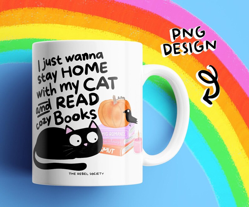 May include: White ceramic mug with a whimsical design. The mug features a black cat, a pumpkin, and stacked books. Text on the mug reads "I just wanna stay HOME with my CAT and READ cozy Books." The mug has a white handle and the words "PNG DESIGN" are also visible.