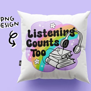 May include: White pillow with a rainbow and cloud design. The text "Listening Counts Too" is in black letters. A stack of books and headphones are in the cloud.
