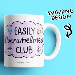 May include: White ceramic mug with a purple cloud design. The cloud has the text "EASILY Overwhelmed CLUB" with a heart, smiley face, and flowers. The text "THE REBEL SOCIETY" is at the bottom of the mug.