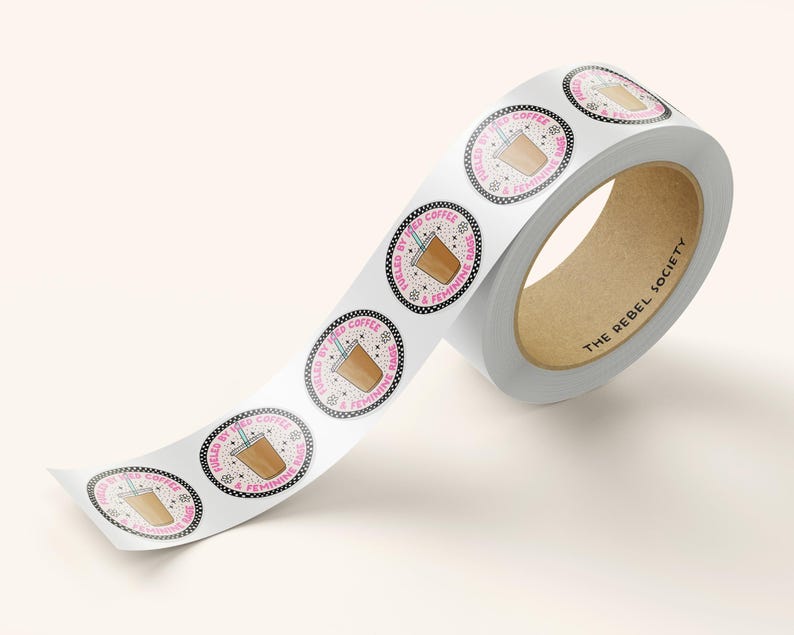 May include: A roll of white sticker tape with round stickers featuring a cartoon illustration of a coffee cup with the text "Fueled by the Coffee & Feminine Rage" in pink and black lettering.