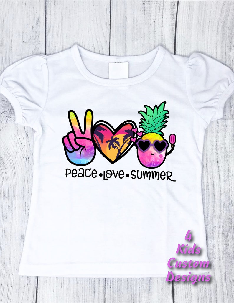 May include: White t-shirt with a peace sign, heart, and pineapple graphic. The graphic is colorful and features a sunset, palm trees, sunglasses, and a popsicle. The text "Peace Love Summer" is printed below the graphic.