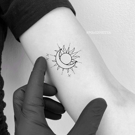 Minimalist sun tattoo on the wrist
