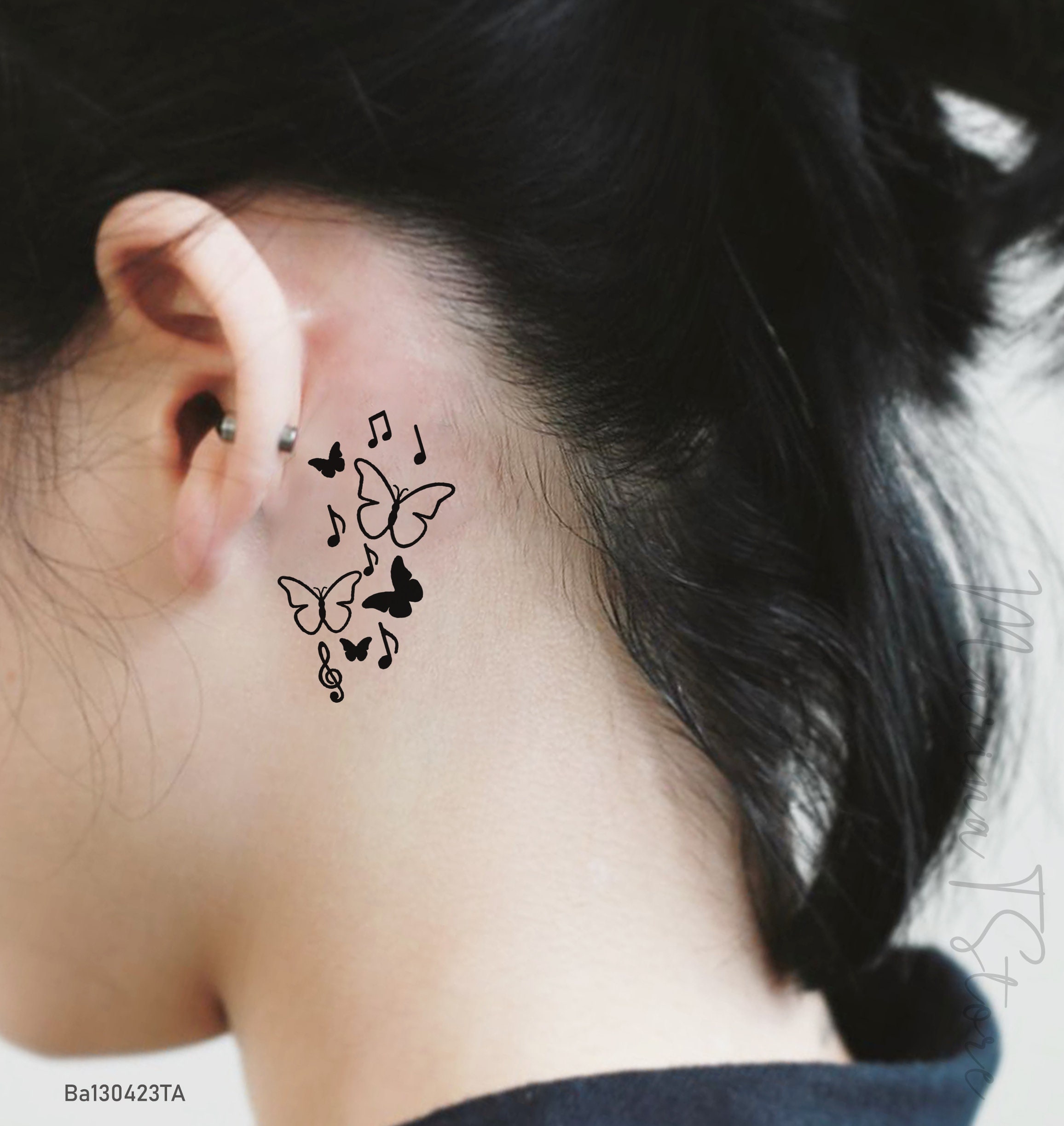 Small butterfly neck tattoo idea for singers