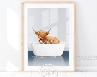 May include: Framed art print featuring a Highland cow relaxing in a white bathtub filled with bubbles. The cow has long, shaggy, reddish-brown fur and large horns. The artwork is set against a light blue and white background, with a wooden frame.